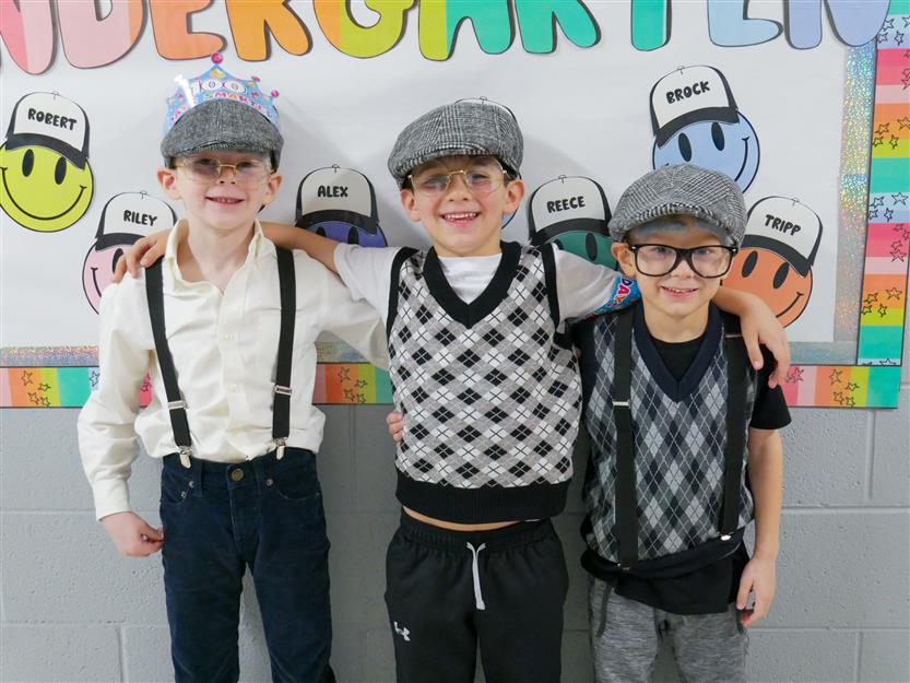 three boys in hats, suspenders and sweater vests